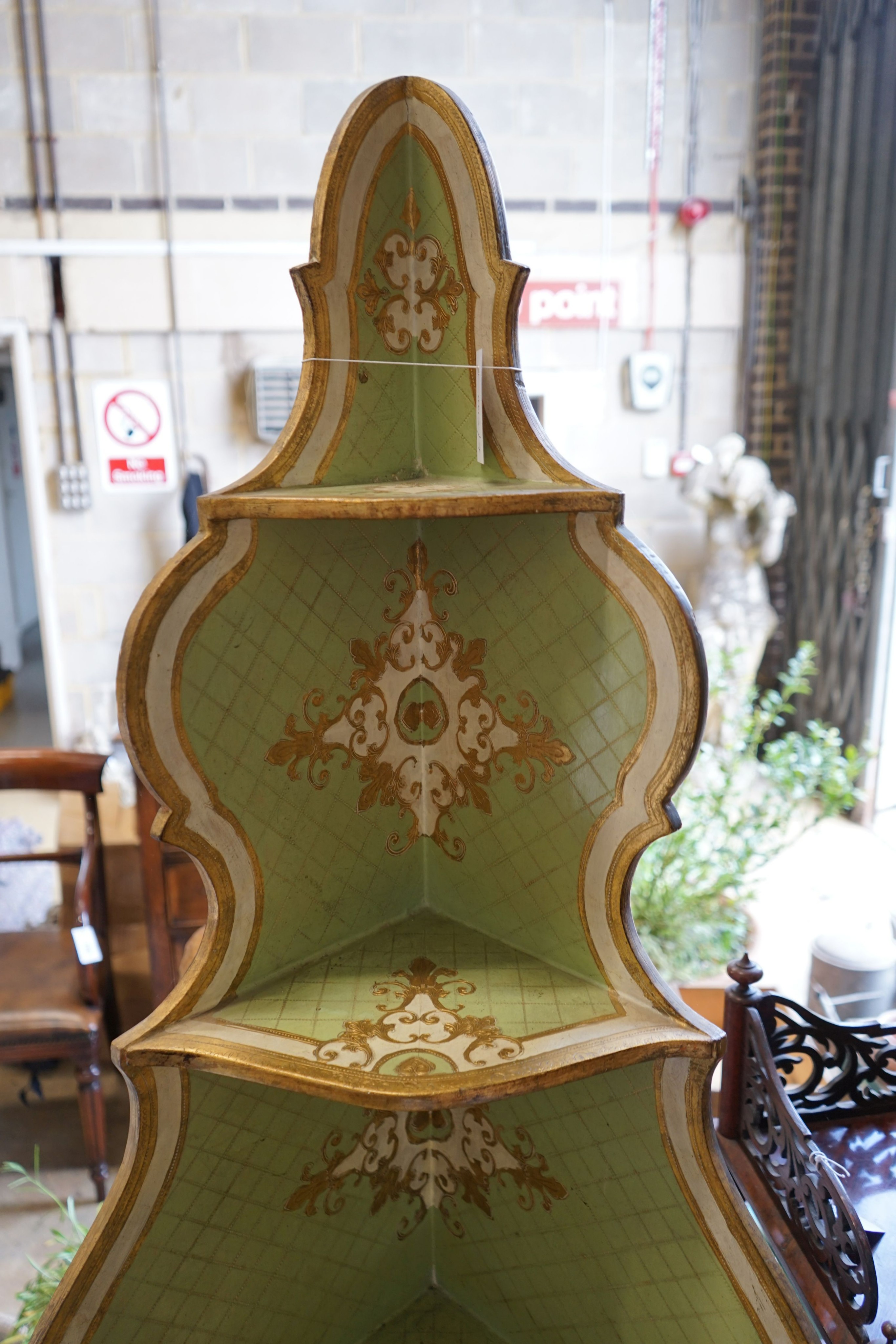 An Italian painted parcel gilt standing corner cabinet, width 57cm, depth 39cm, height 189cm